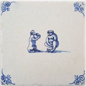 Antique Delft tile with two monkeys drinking from a cup, 17th century